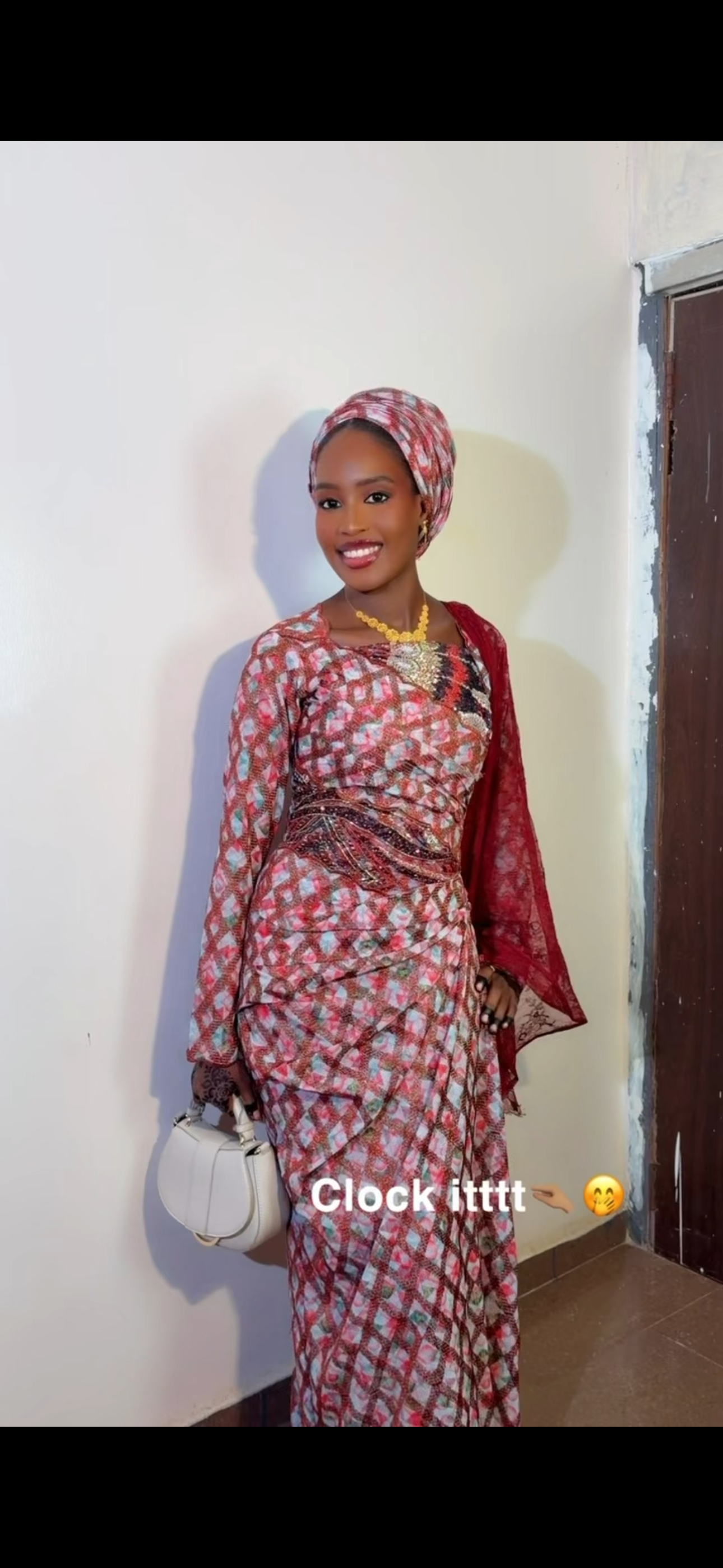 Indo smiling in a red traditional outfit